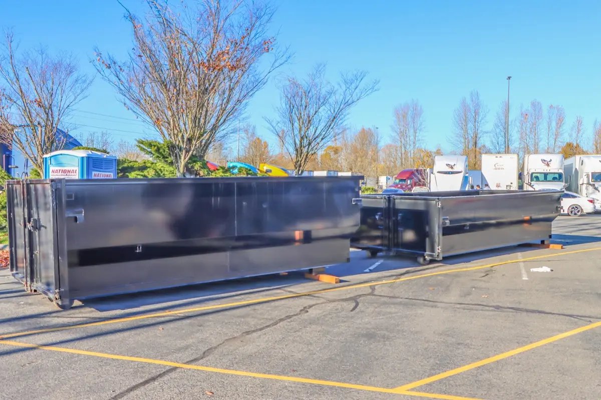 Professional dumpster rental service with roll-off container on residential driveway in Coral Gables